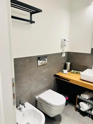 a bathroom with a white toilet and a sink at RESIDENZA 62 in Rome