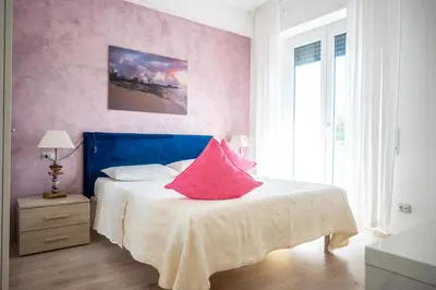 a bedroom with a bed with pink pillows on it at Families apartment in Rome