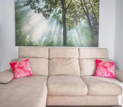 a couch with two pink pillows in a living room at Families apartment in Rome