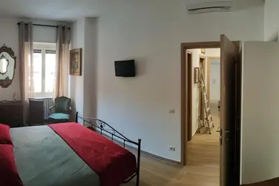 a bedroom with a bed and a hallway with a mirror at THERESA APARTMENT in Rome