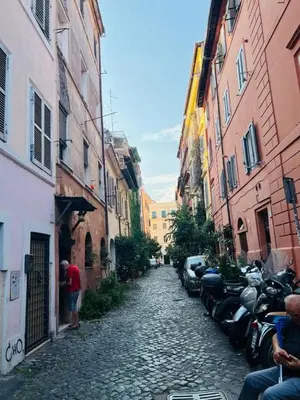 a cobblestone alley with parked motorcycles in a city at La Casa di Cinzia in Rome