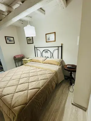 a bedroom with a large bed and a table at La Casa di Cinzia in Rome