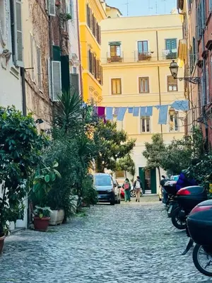 a cobblestone street in a city with buildings at La Casa di Cinzia in Rome