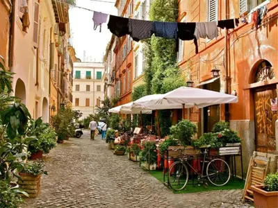 a street with a market with a bicycle and an umbrella at La Casa di Cinzia in Rome
