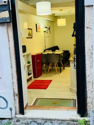 a view of a living room with a table and chairs at La Casa di Cinzia in Rome