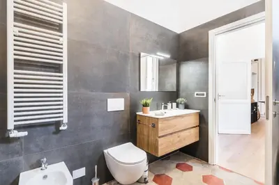 a bathroom with a toilet and a sink at The best in Rome Monserrato in Rome