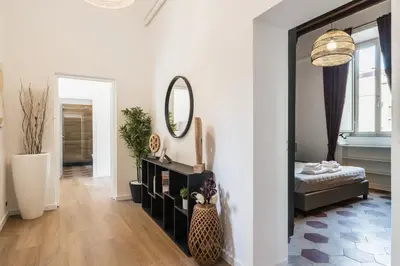 a living room with a bed and a mirror at The best in Rome Monserrato in Rome