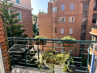 a balcony with potted plants on a building at Circo Massimo Sweet Home - next to FAO in Rome