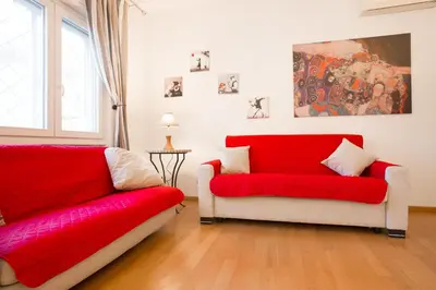 two red and white chairs in a living room at Lovely apartment in Rome - Casetta Mattei in Rome