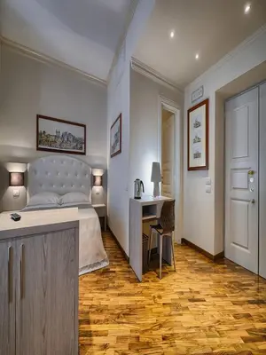 a bedroom with a bed and a desk and a table at Polinari Rooms San Pietro Roma in Rome