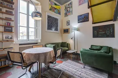 a living room with green furniture and a table at the happy suite, just renovated in Rome