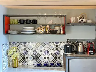 a kitchen with blue and white tiles on the wall at the happy suite, just renovated in Rome