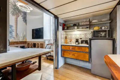 a kitchen with a table and a refrigerator at the happy suite, just renovated in Rome