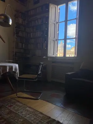 a living room with a chair and a window at the happy suite, just renovated in Rome