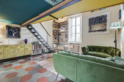 a living room with green couches and a staircase at the happy suite, just renovated in Rome