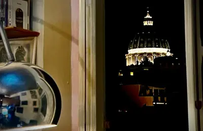a view of a domed building at night at the happy suite, just renovated in Rome