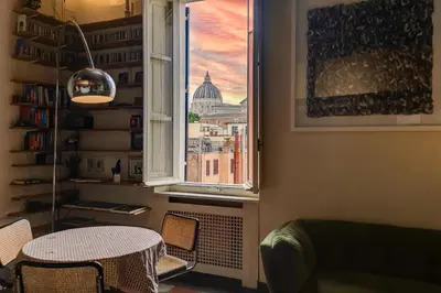 a window with a table and a view of a city at the happy suite, just renovated in Rome