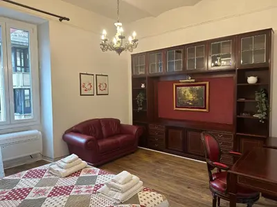 a living room with a table and a chair at La casetta a monti in Rome