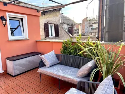 a patio with a bench on a balcony at New! Uptown Terraces in Rome