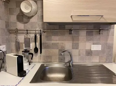 a kitchen counter with a sink and a microwave at New! Uptown Terraces in Rome