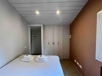 a bedroom with a bed with towels on it at New! Uptown Terraces in Rome