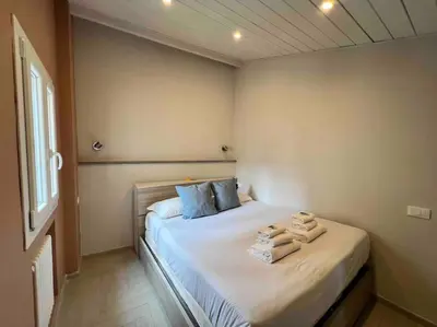a bedroom with a bed with towels on it at New! Uptown Terraces in Rome
