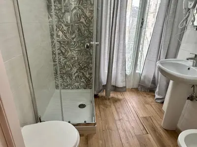a bathroom with a shower and a toilet and a sink at GOLDEN ROOMS Cipro in Rome