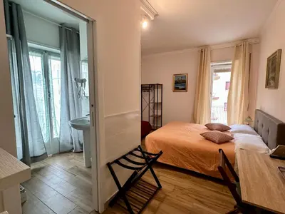 a small bedroom with a bed and a bathroom at GOLDEN ROOMS Cipro in Rome