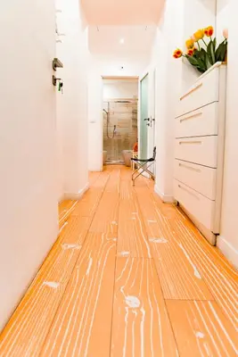a hallway with a wooden floor with drawings on it at Divine Bed & Breakfast in Rome