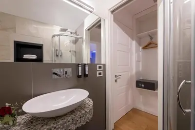 a bathroom with a large white sink on a stool at Argentina Residenza Style Hotel in Rome