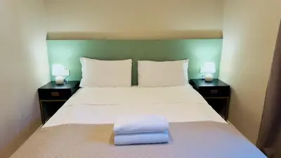 a bedroom with a large bed with two night stands at Hotel Sallustio in Rome