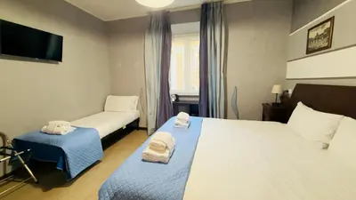 a hotel room with two beds and a tv at Hotel Sallustio in Rome