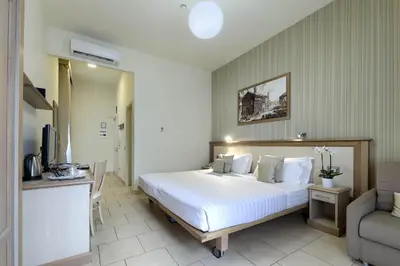 a hotel room with a bed and a chair at Domus Australia in Rome