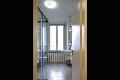 a bathroom with a sink and a toilet and a window at Domus Australia in Rome
