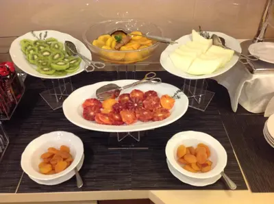 a table with plates of fruits and vegetables on it at Domus Australia in Rome
