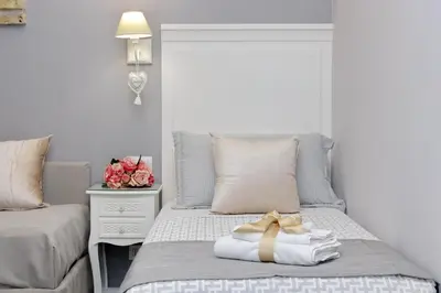 a bedroom with a bed with a gold ribbon on it at Roman Holiday Suites in Rome