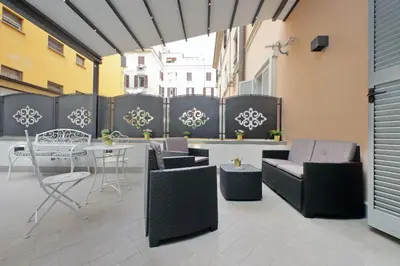 a patio with furniture and a table and chairs at Roman Holiday Suites in Rome