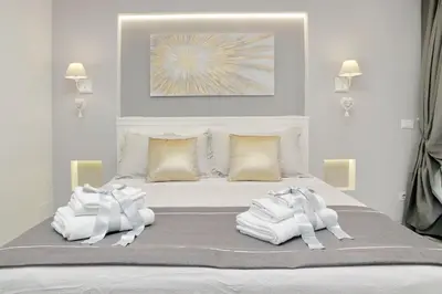 a bedroom with a bed with white towels on it at Roman Holiday Suites in Rome