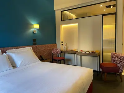 a bedroom with a bed and a table with chairs at Passpartout Boutique Palace in Rome