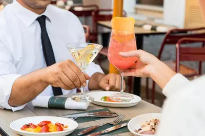 a group of people sitting at a table with drinks at Passpartout Boutique Palace in Rome