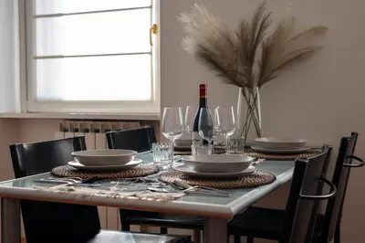 a dining table with glasses and a bottle of wine at Domus Montebello in Rome