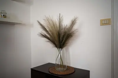 a vase with feathers in it on a table at Domus Montebello in Rome