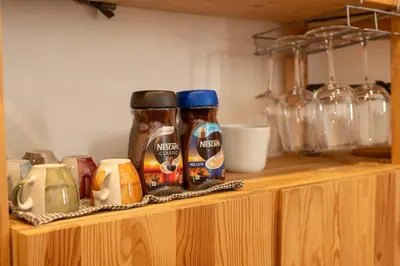 a wooden shelf with jars of condiments on it at Domus Montebello in Rome