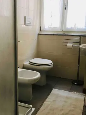 a bathroom with a toilet and a sink at d-cube camera Colosseo in Rome