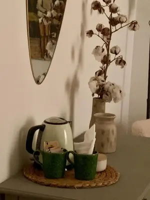 a table with two green cups and a tea kettle at d-cube camera Colosseo in Rome
