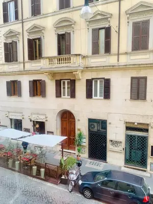 a car parked in front of a building at d-cube camera Colosseo in Rome