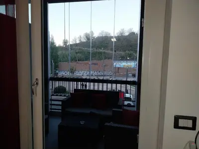 a living room with a couch and a large window at j u b i l e h o u s e R o m e in Rome