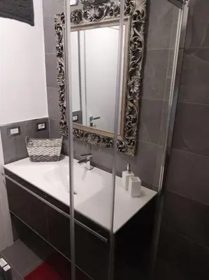 a bathroom with a sink and a mirror at j u b i l e h o u s e R o m e in Rome