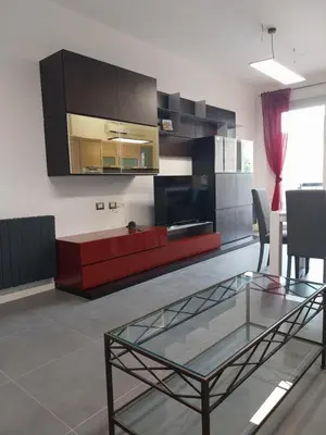 a living room with a red couch and a glass table at j u b i l e h o u s e R o m e in Rome