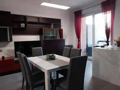 a living room with a dining room table and chairs at j u b i l e h o u s e R o m e in Rome